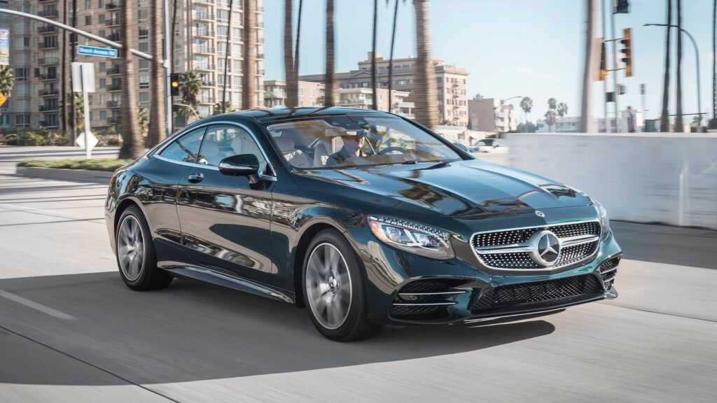 Mercedes-Benz S560 luxury coupe driving in the city.