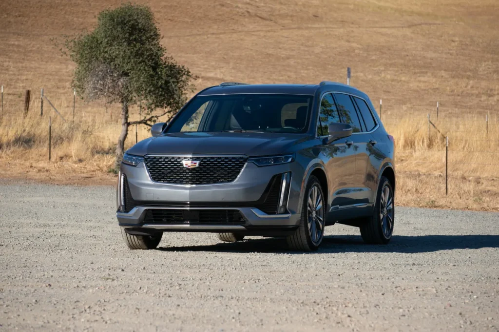 Sleek Cadillac XT6 luxury SUV in metallic gray parked outdoors United Limo INC limo service vehicle.