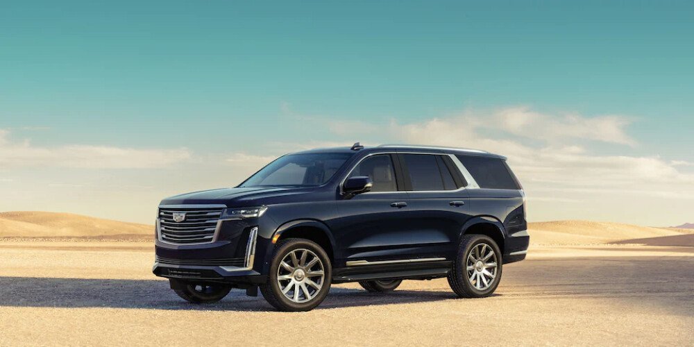 Black Cadillac Escalade luxury SUV parked in a scenic desert landscape premium limo service by United Limo INC.