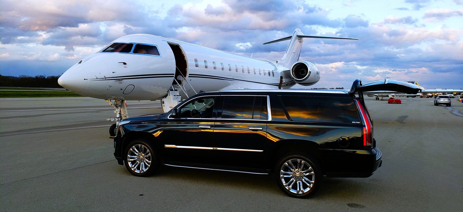 Luxury black SUV parked beside a private jet at the runway, representing United Limo INC’s elite airport limo service in New York.